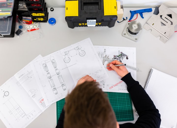 An engineering desk with measuring and drawing tools